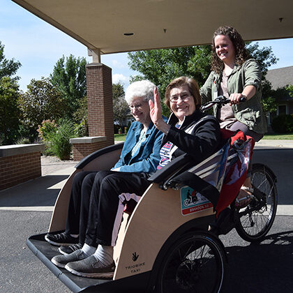 Residents from Bethany Meadows enjoy a ride in a Trio Bike
